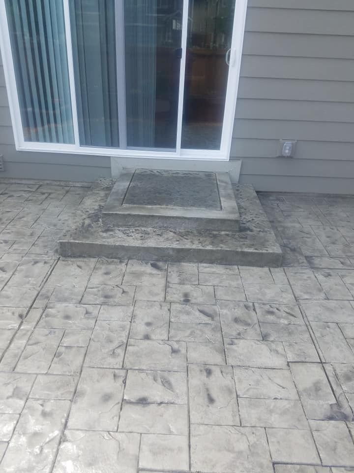 Custom concrete patio flatwork with integrated landing at sliding glass door