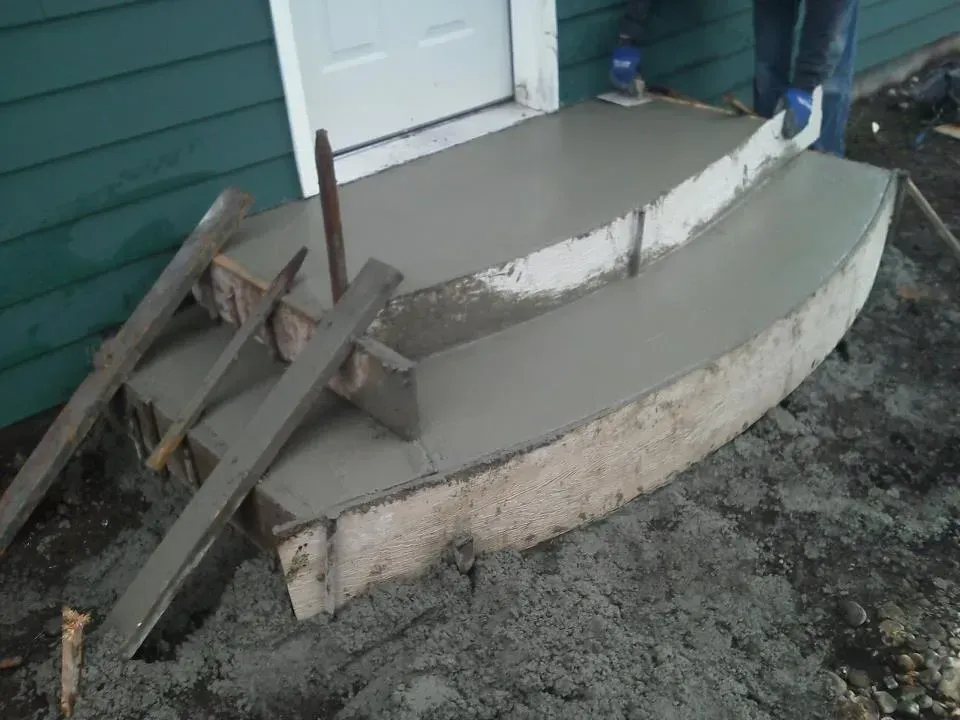 Curved concrete steps under construction with wood formwork