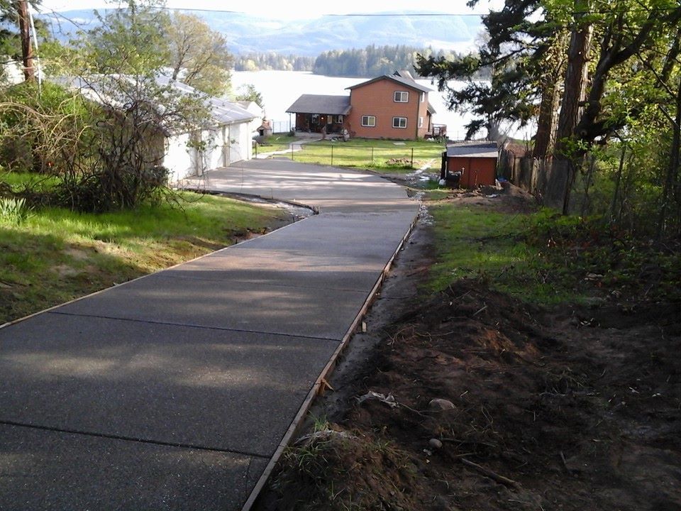 Long residential concrete driveway replacement on rural lot