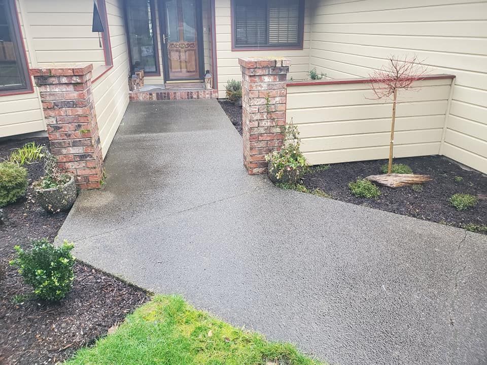 Exposed aggregate concrete walkway leading to front entry