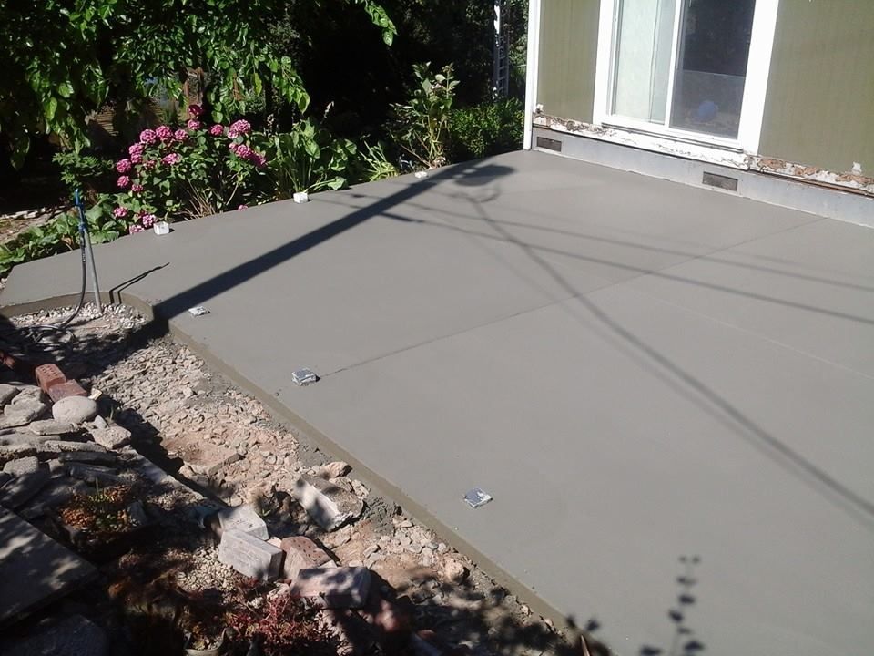 Steel trowel finished concrete slab installed for backyard entertaining