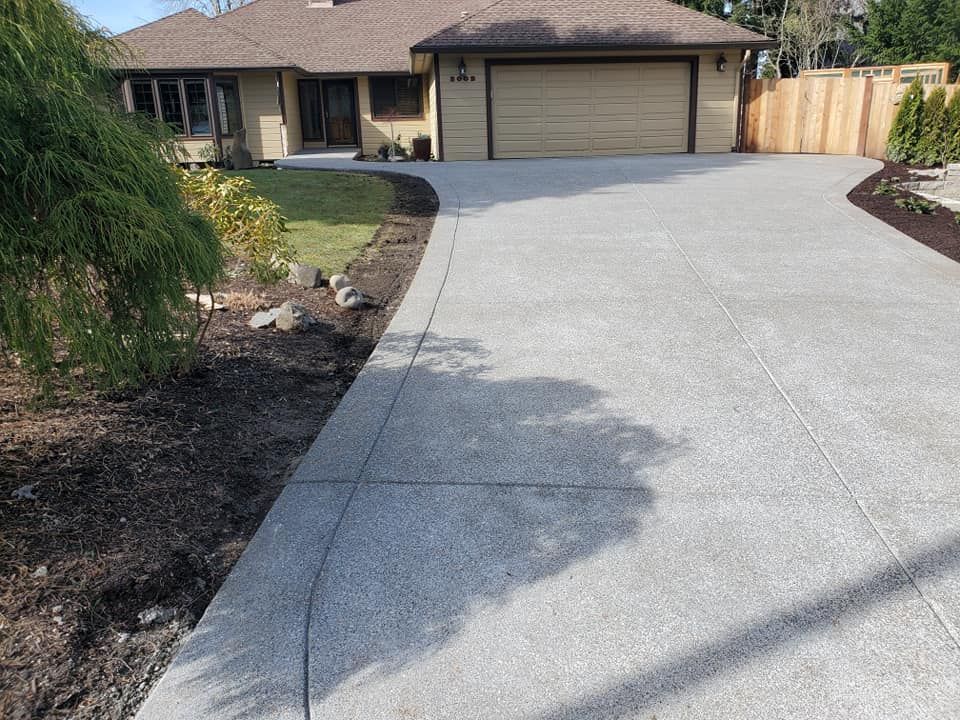Exposed aggregate concrete driveway with curved design