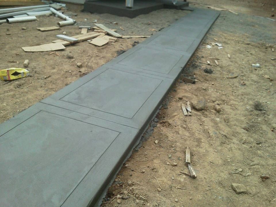 Residential concrete sidewalk with bordered panel layout