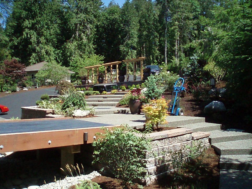 Concrete terrace with smooth stained concrete walkways and aggregate stairs
