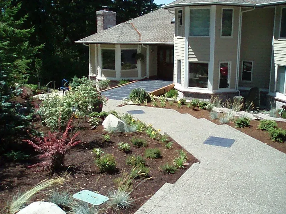 Curved exposed aggregate concrete walkway installation in Lacey WA