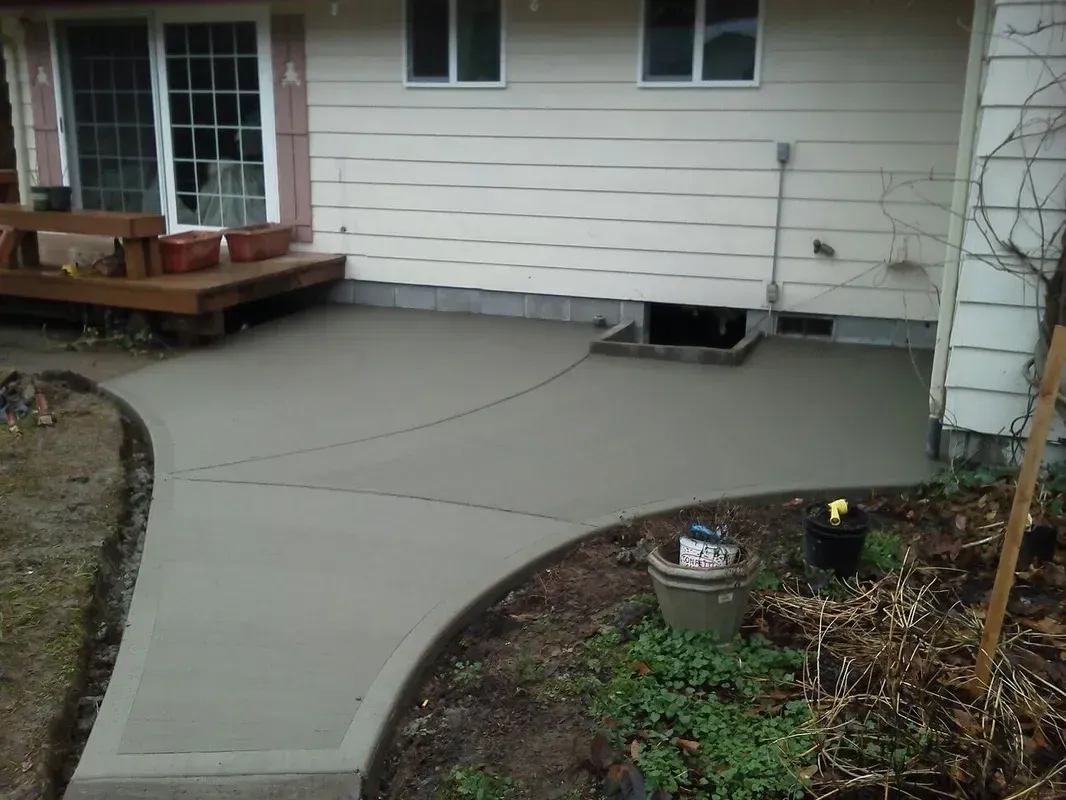 Custom curved concrete flatwork connecting home and landscape