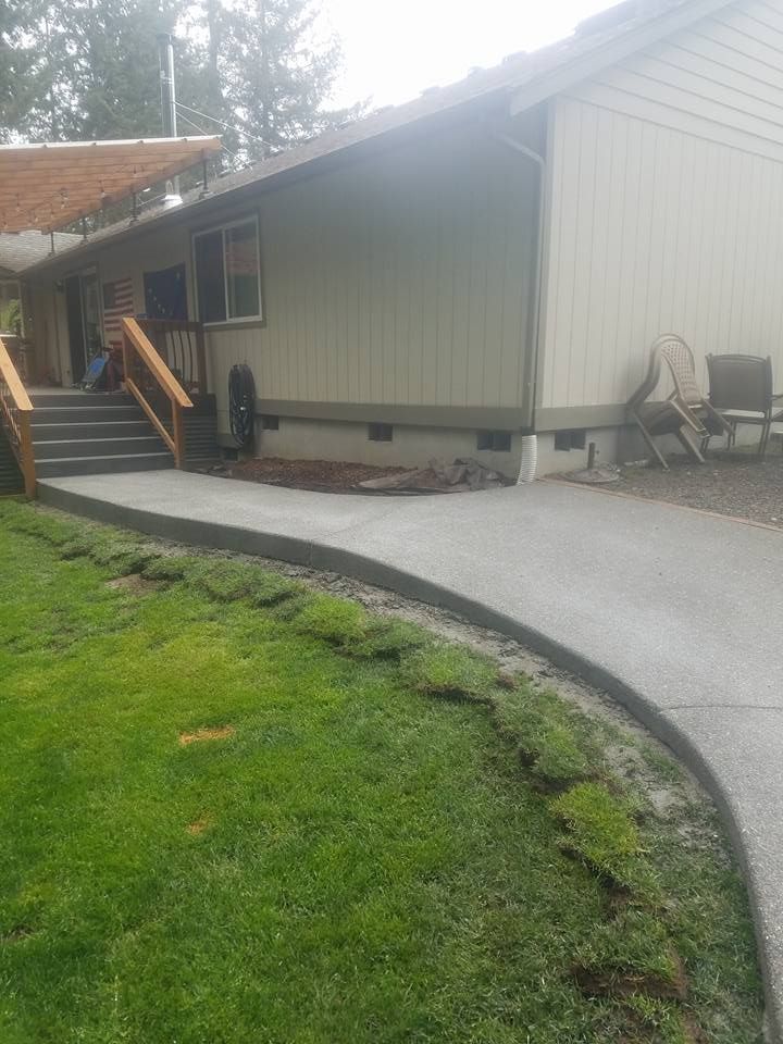 Decorative pebble finish concrete path with sweeping curve
