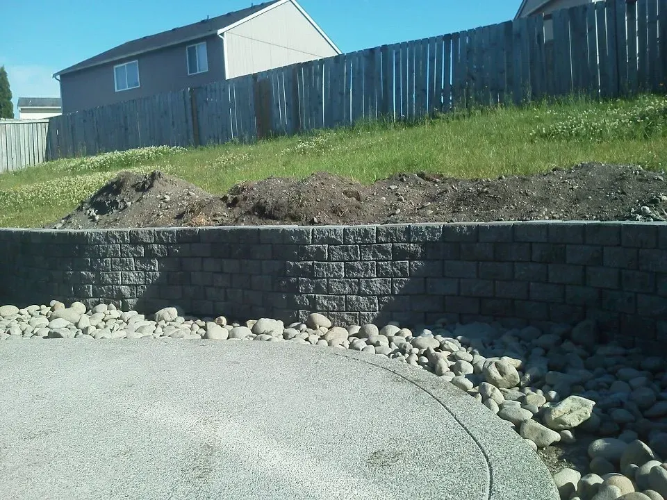 Exposed aggregate concrete patio with retaining wall in Lacey WA