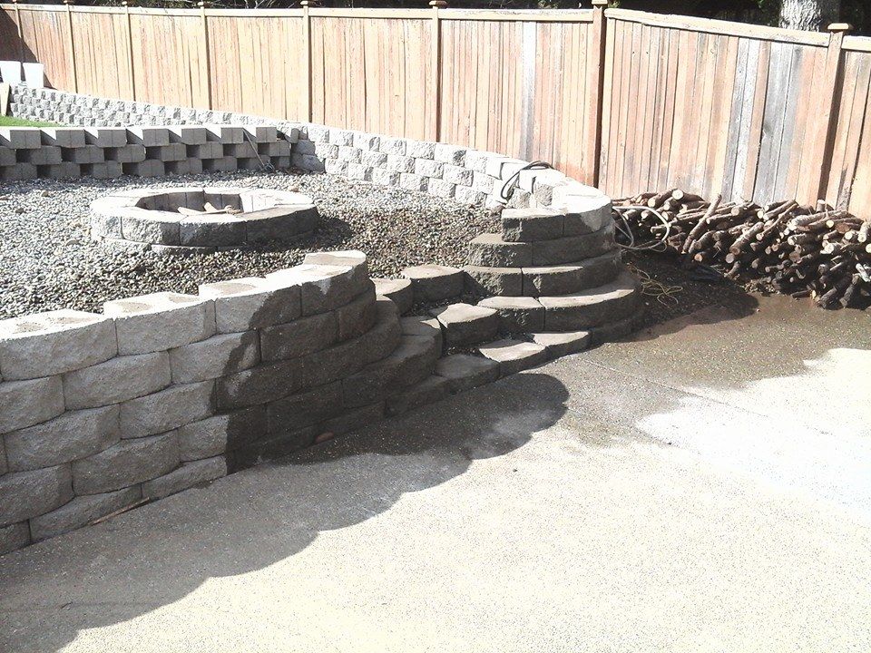 Segmental block retaining wall with integrated concrete patio surface