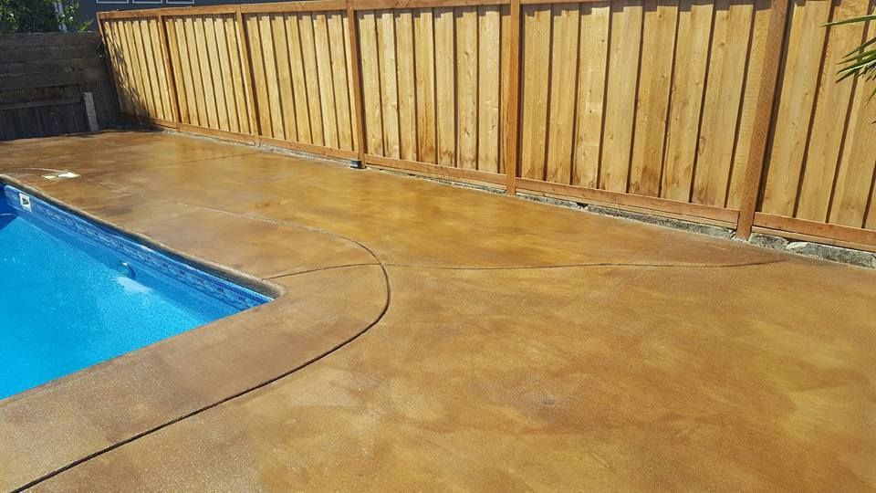 Custom concrete pool deck installation with seamless edge design