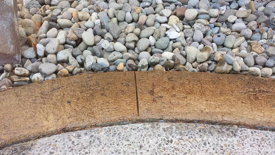 Custom stamped concrete garden border installation