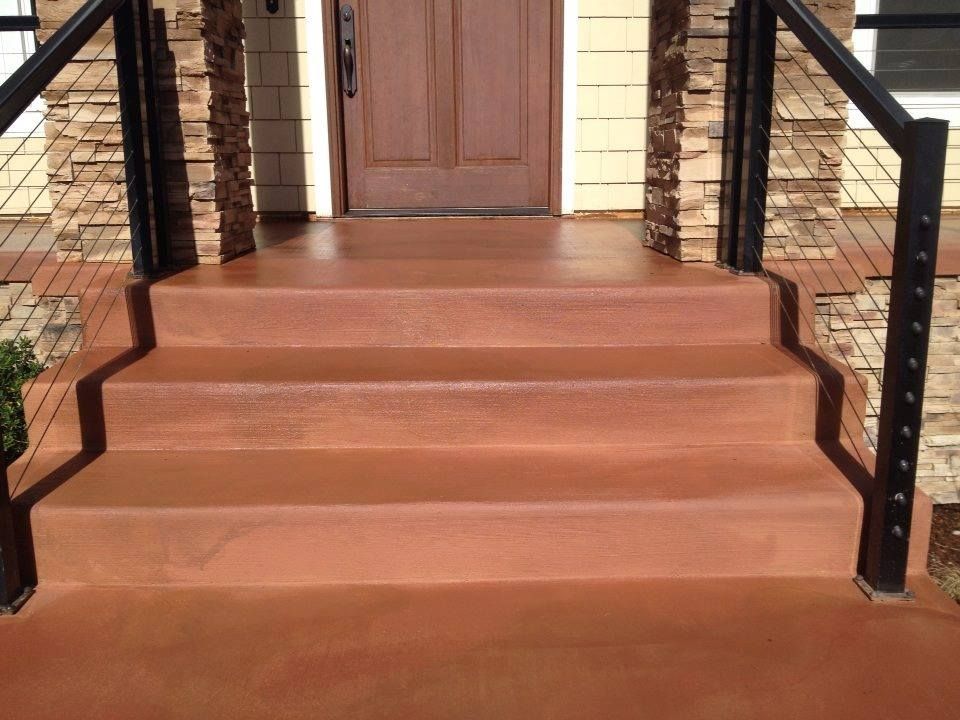 Stained concrete front steps with warm brown finish and clean edges