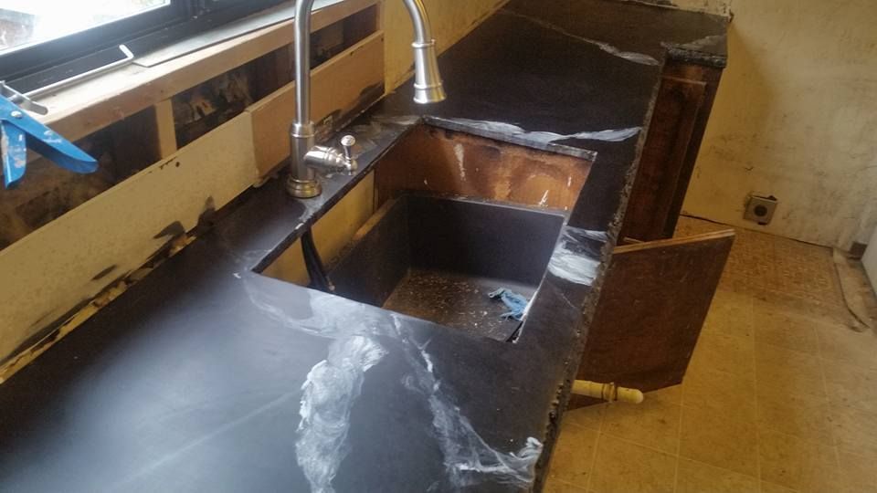 Custom concrete countertop with integrated sink basin installation