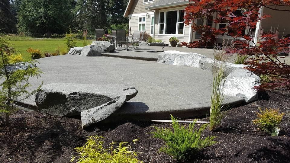 Decorative backyard patio with textured concrete finish