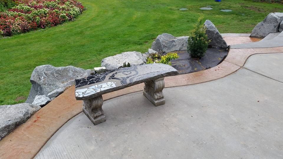 Decorative concrete garden bench with mosaic inlay surface