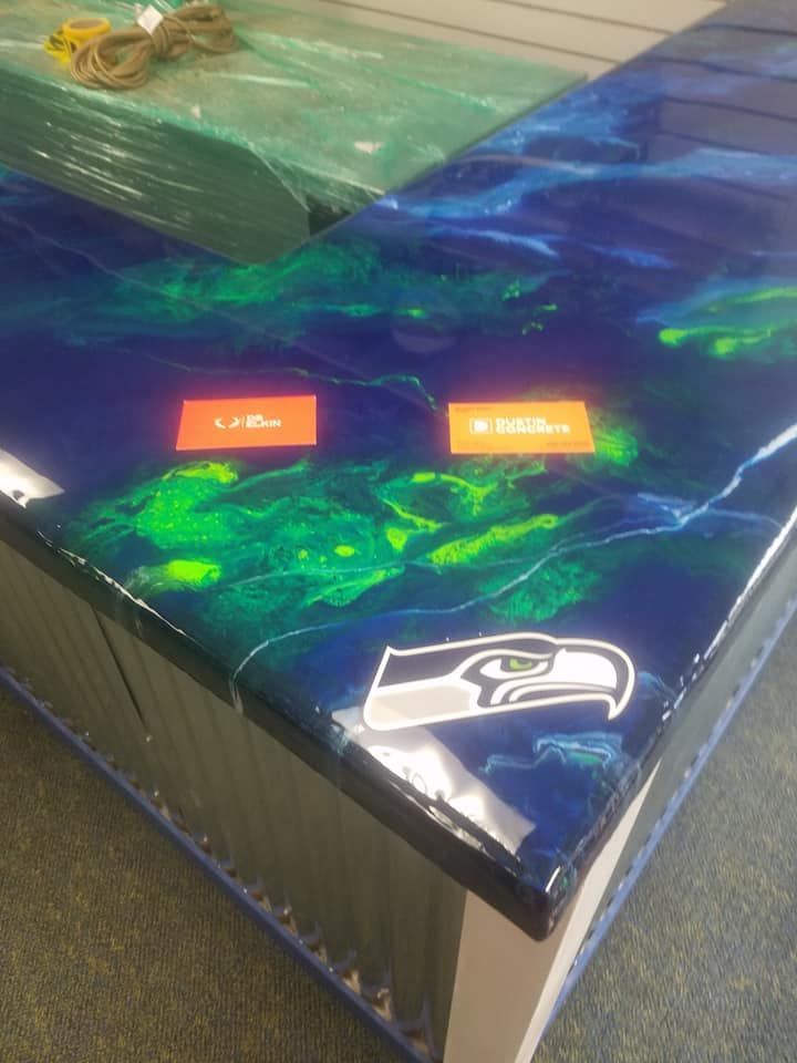 Custom epoxy countertop with metallic blue and green swirl design