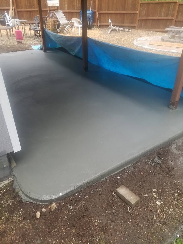 Freshly finished smooth concrete pad protected by the weather for curing