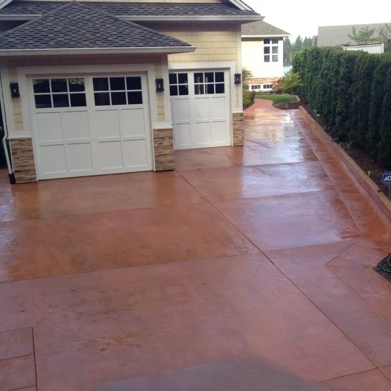 Stained concrete driveway with smooth finish and clean expansion joints