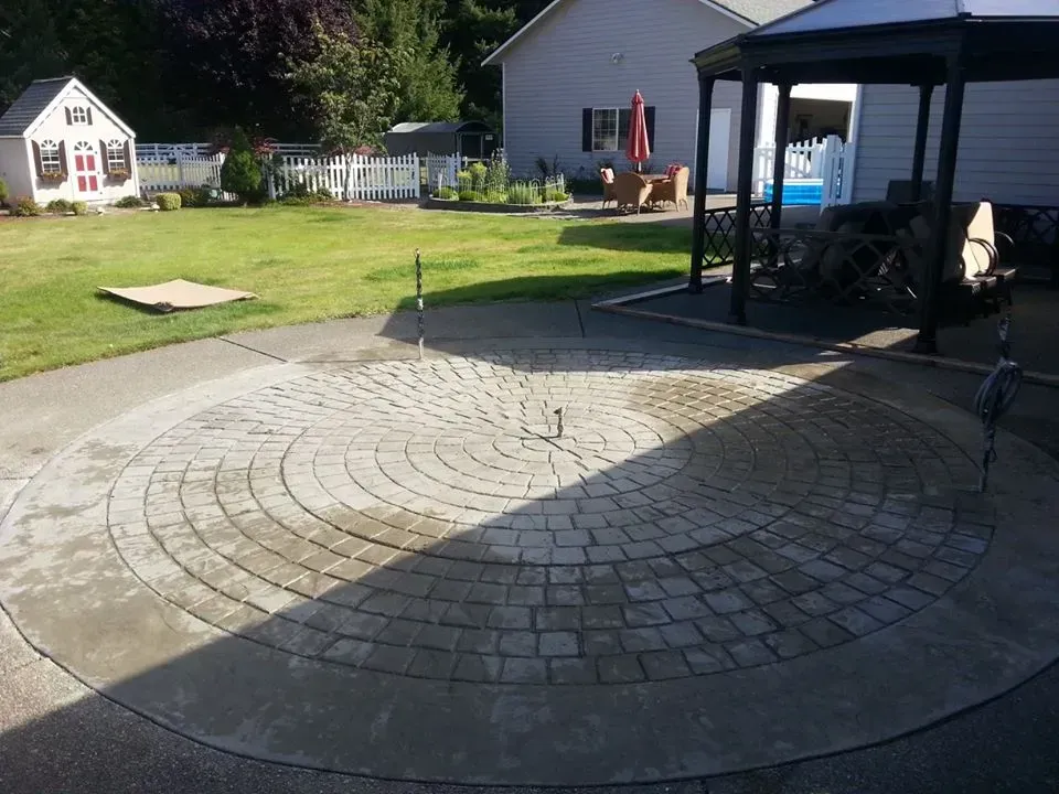 Decorative concrete patio featuring round brick style layout