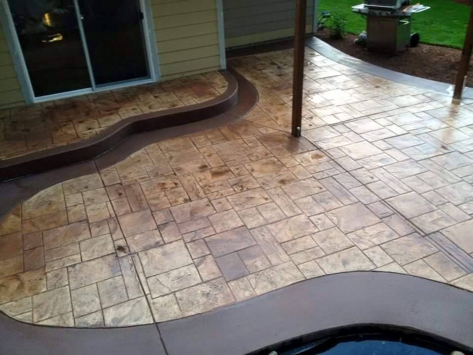 Stamped concrete patio with curved border and wood plank texture finish