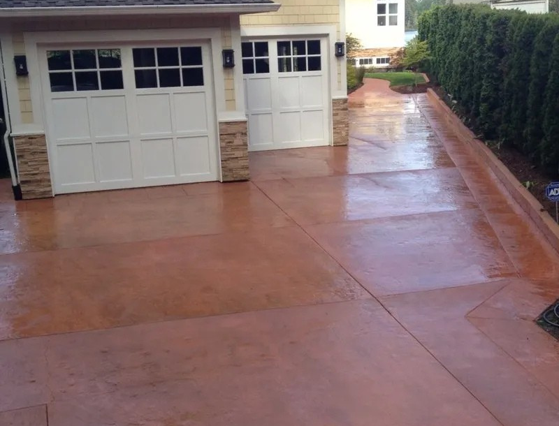 Decorative concrete flatwork leading to dual garage entry