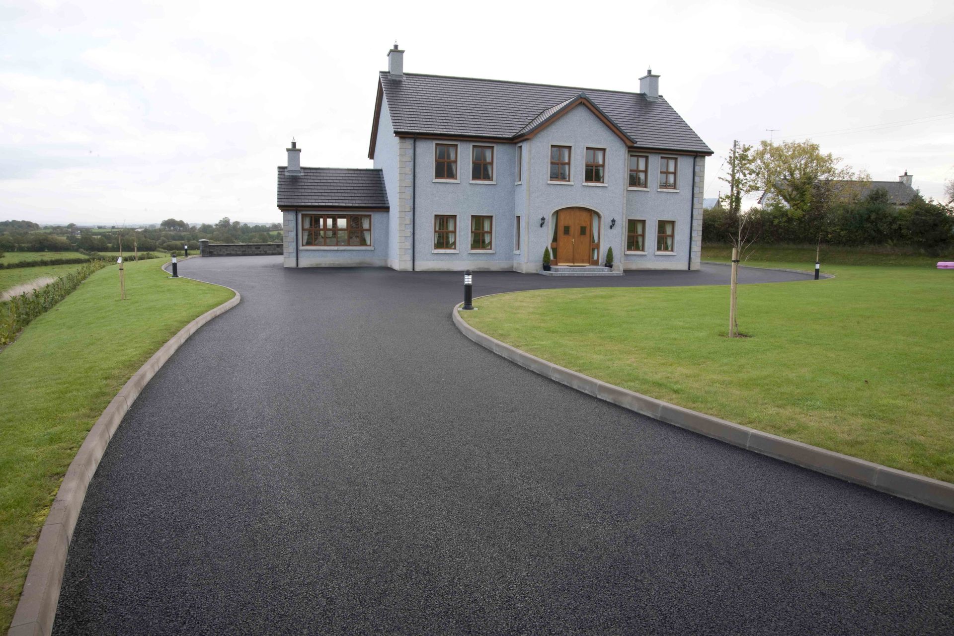 An asphalt driveway being sealed to protect and extend its lifespan.