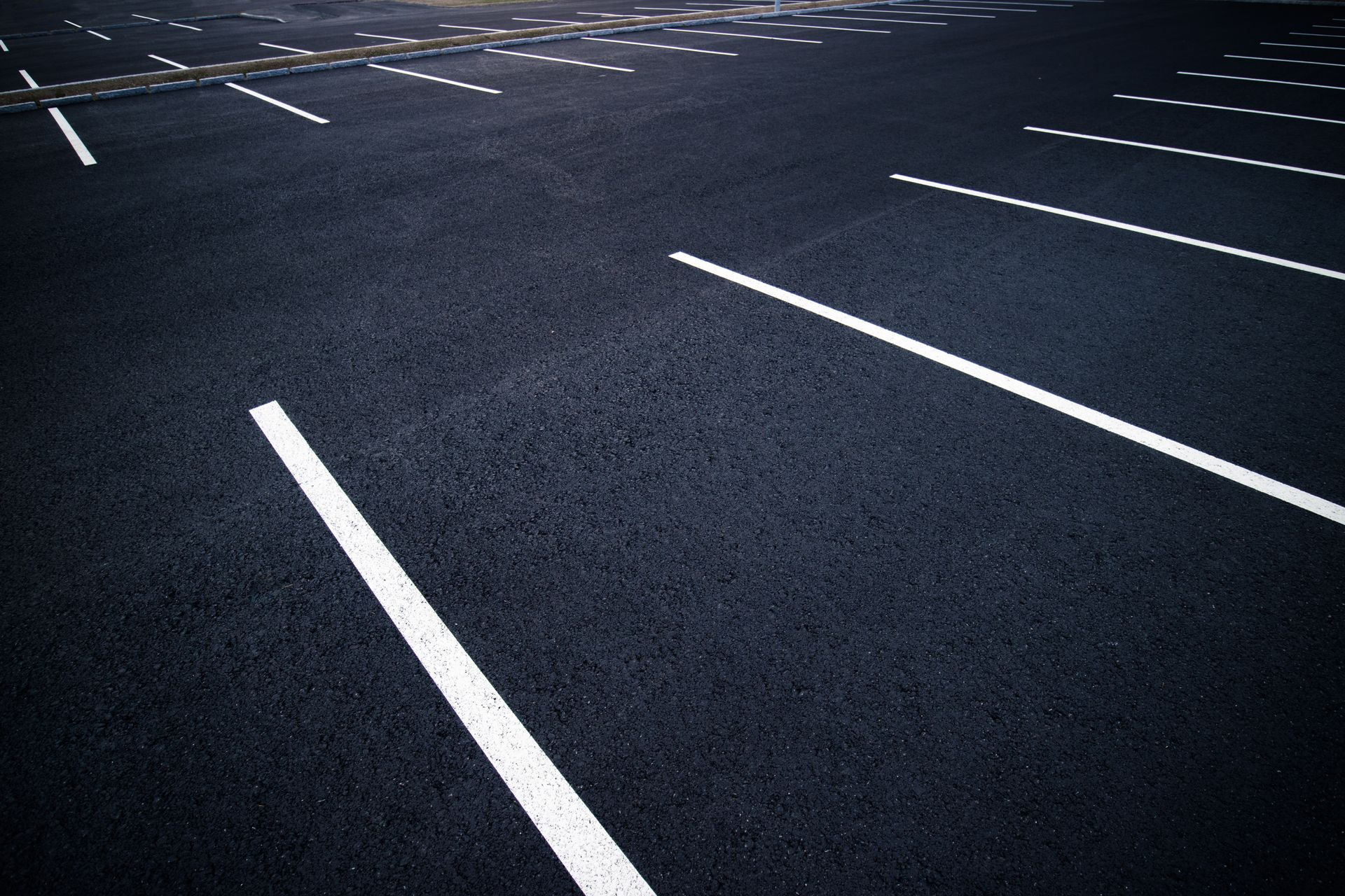 Empty car parking lots with no vehicles in sight, creating a vast expanse of open space and vacant parking spots.
