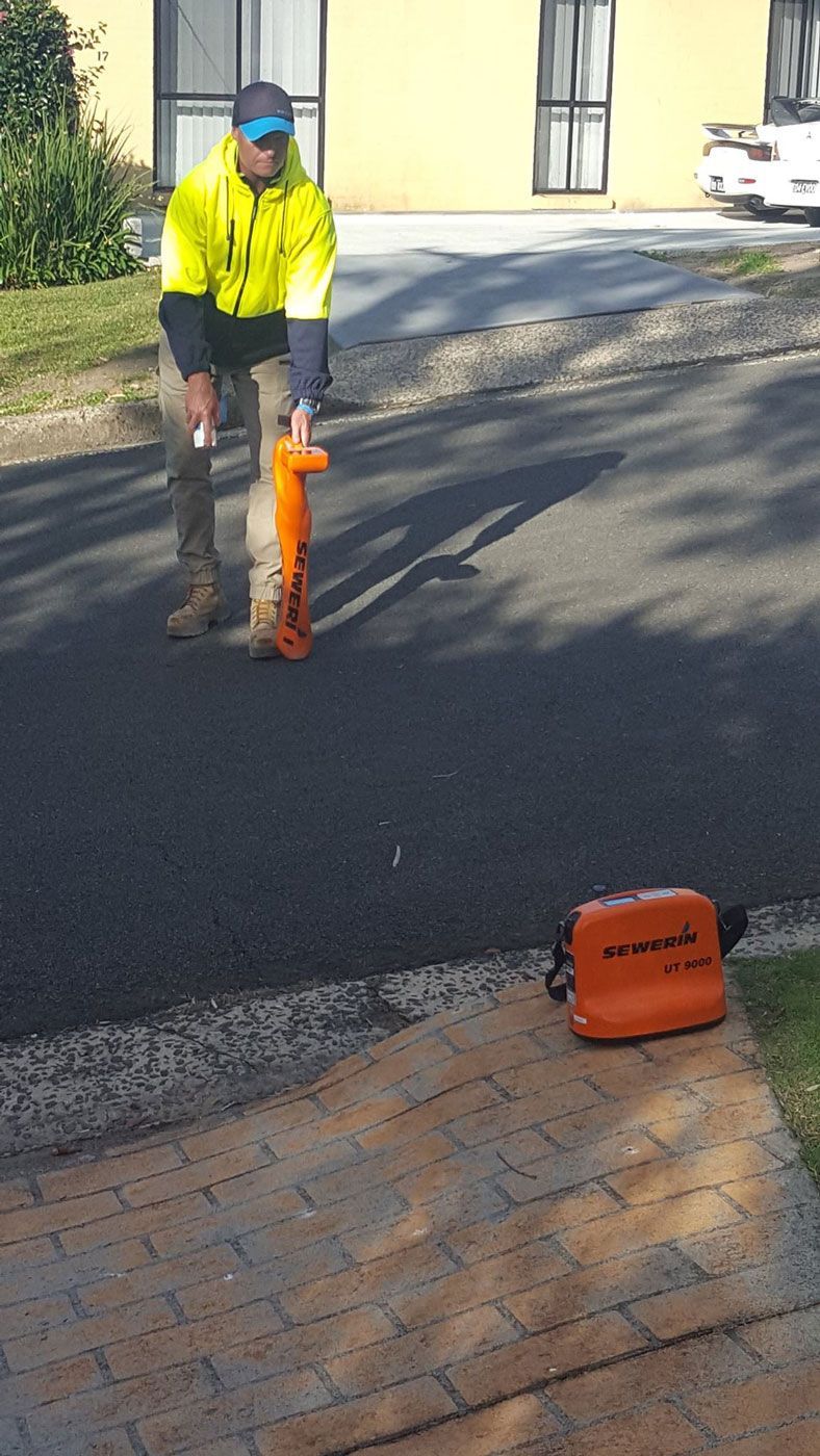 Man Using An Equipment To Locate Cable