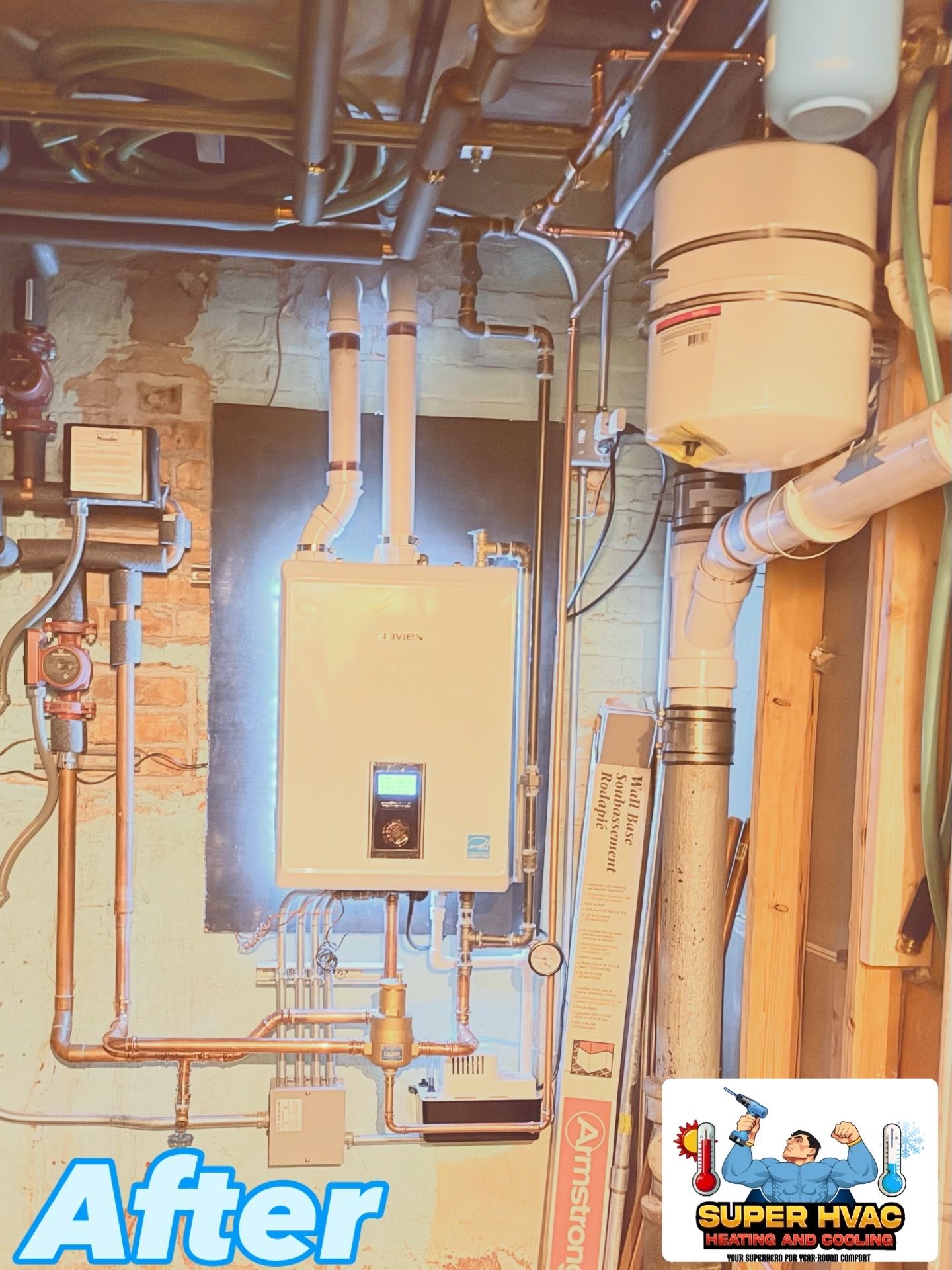 A before photo of a boiler and related piping installed on a painted concrete wall.