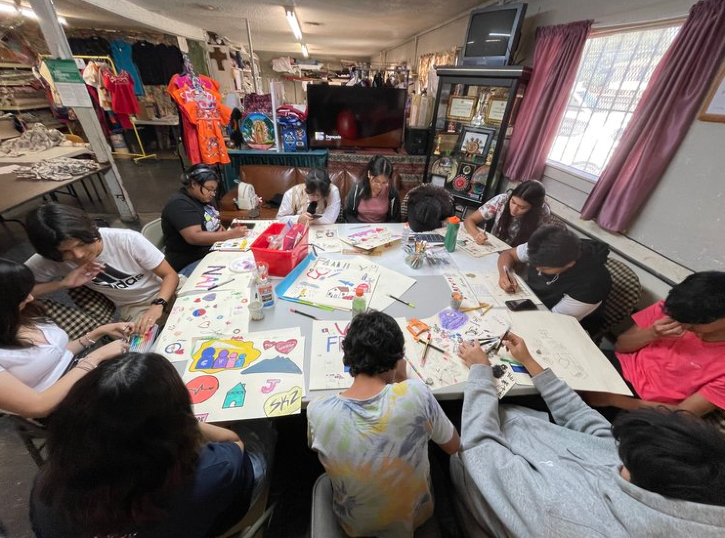 A group of people are sitting around a table in a room.