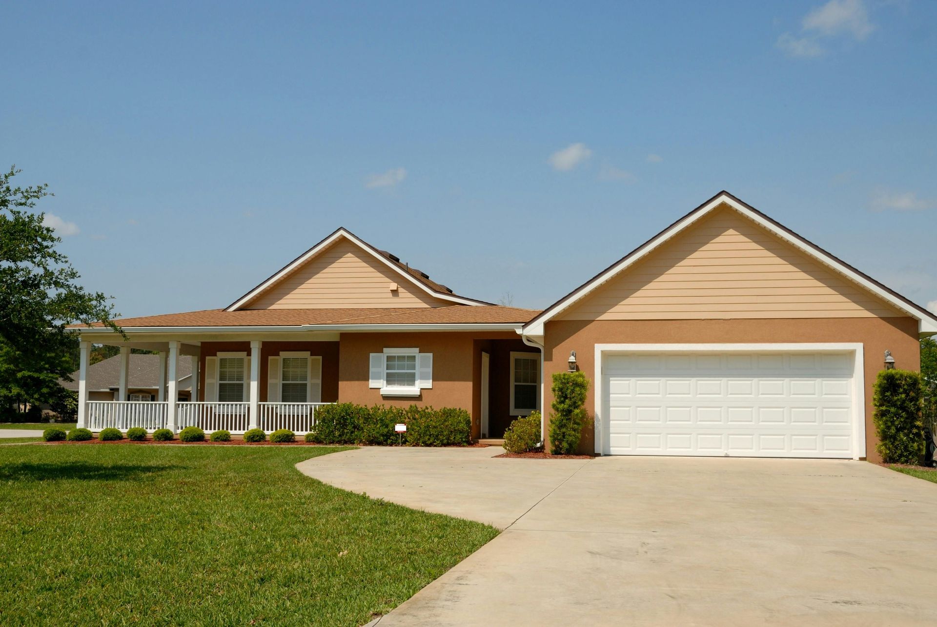 A large house featuring a spacious driveway, showcasing its elegant architecture.