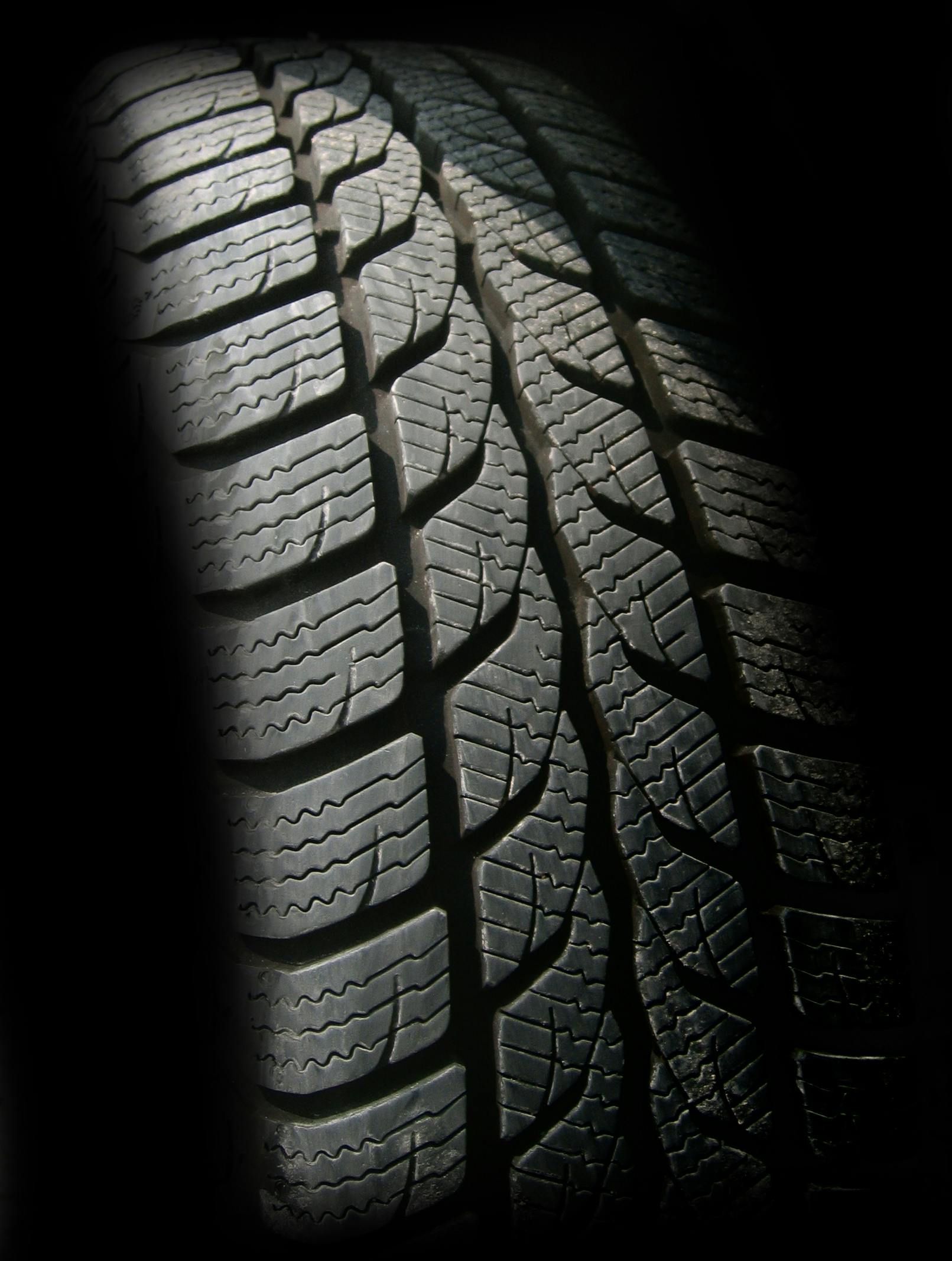 A close up of a tire on a black background