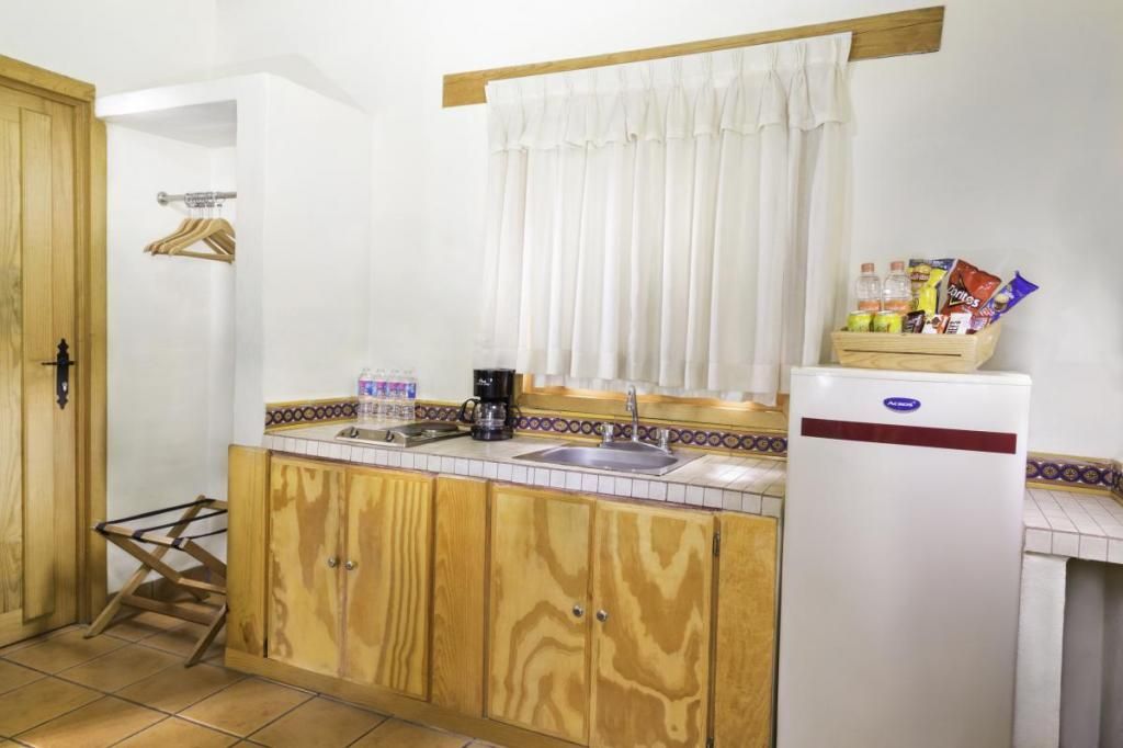 A kitchen with wooden cabinets and a white refrigerator.