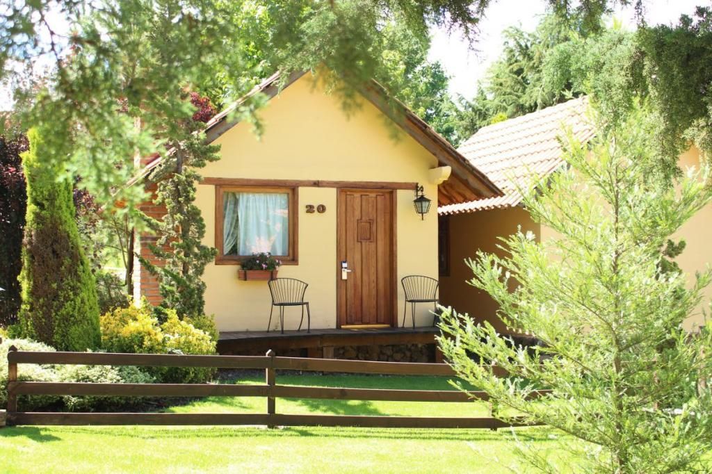 A small house with a wooden fence in front of it