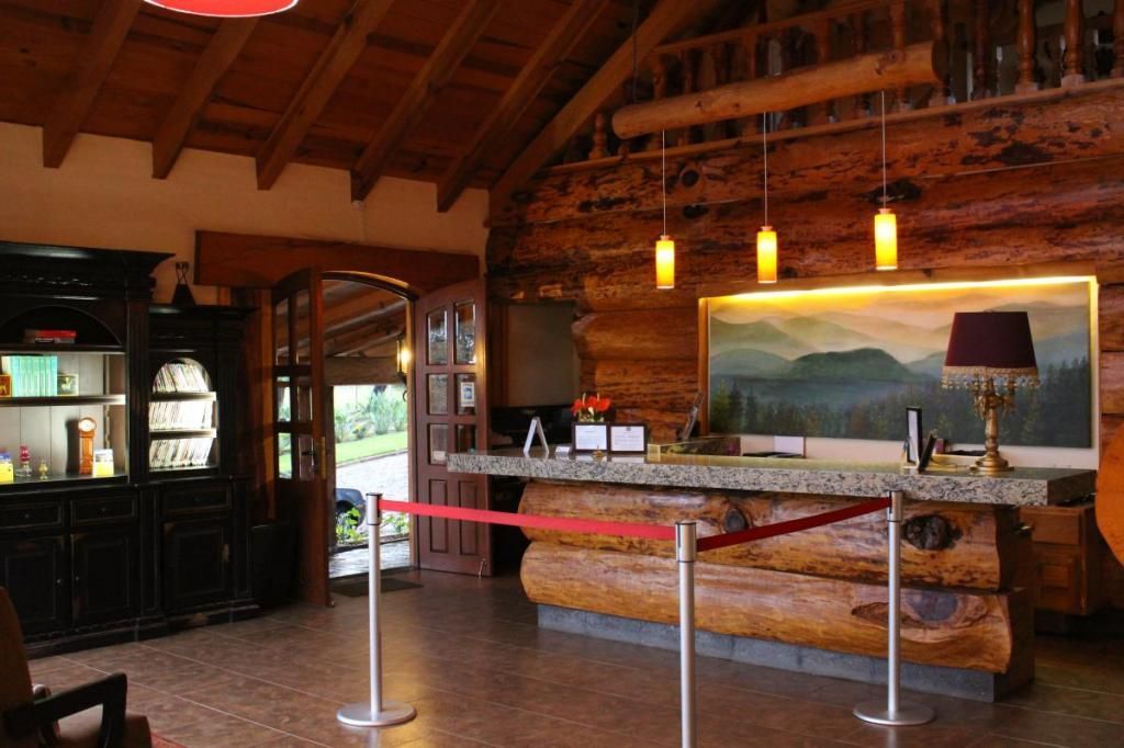 A log cabin with a reception desk and a painting on the wall