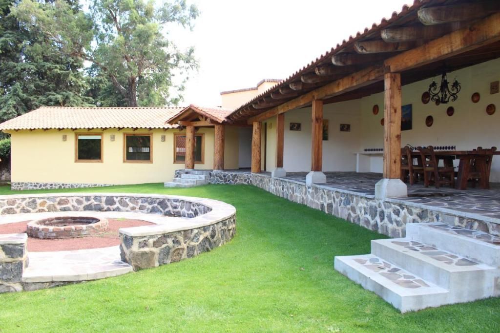 A house with a fire pit in front of it