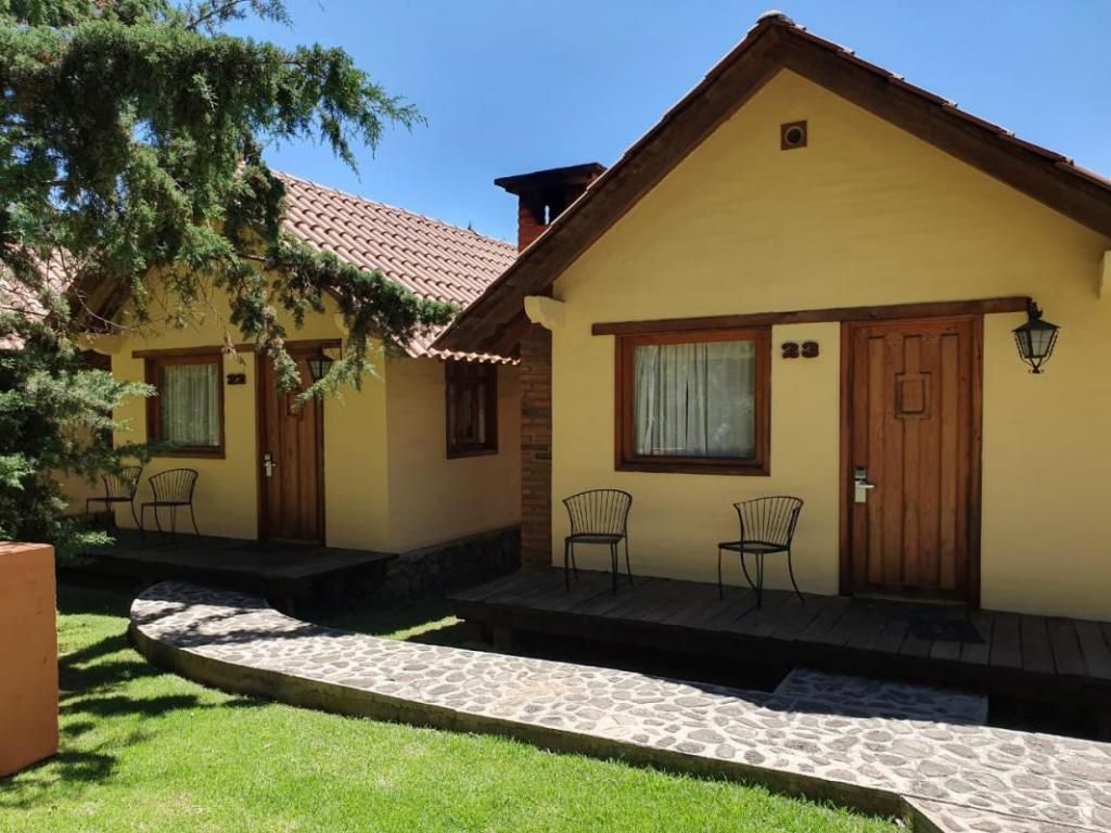 A small house with a brick walkway leading to it