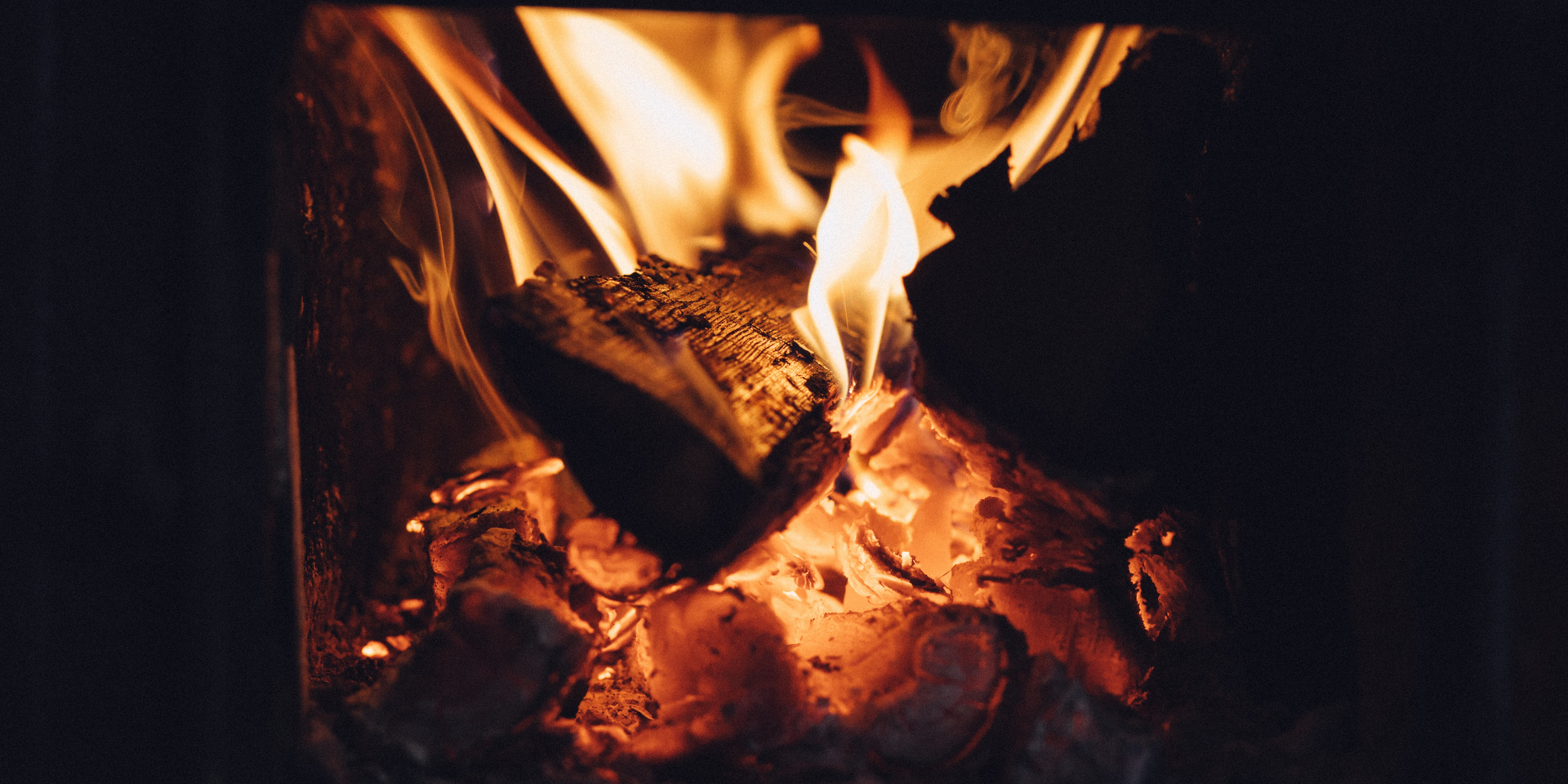 woman sitting by fireplace