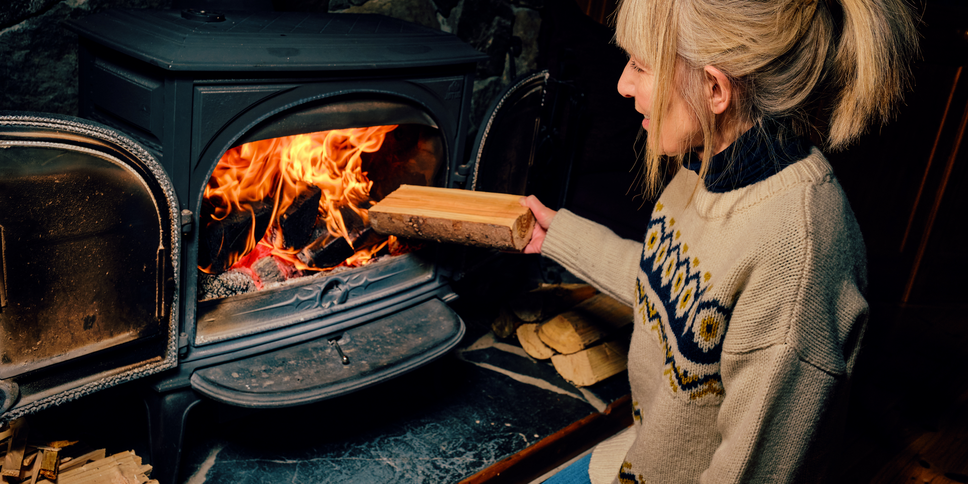 woman sitting by fireplace