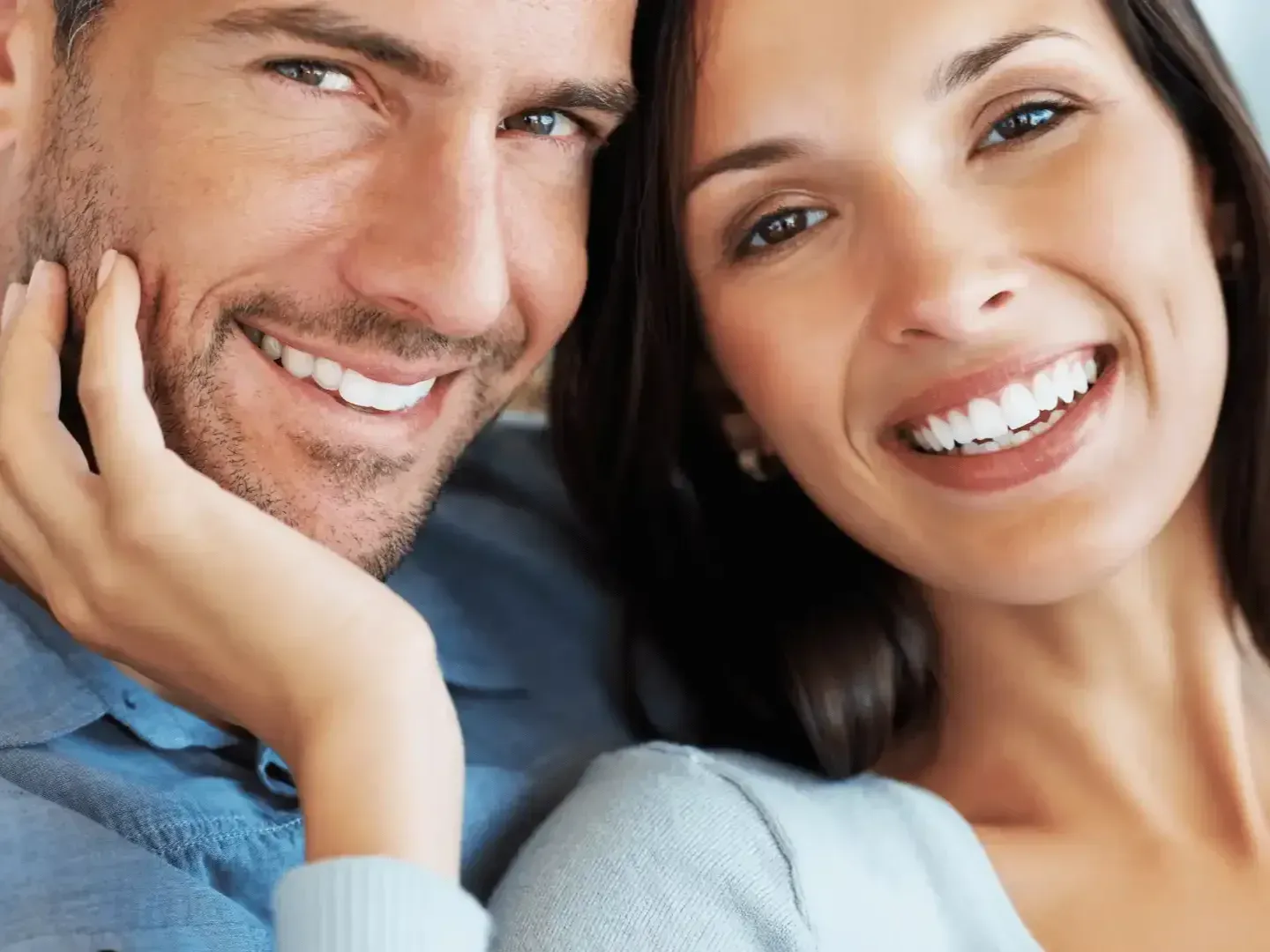 A man and a woman are smiling for the camera.