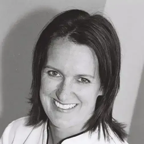 a woman is smiling in a black and white photo