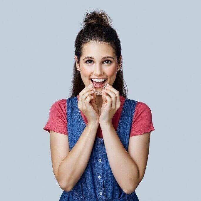Woman smiling with Invisalign Aligners - Duxton Dental Children's Dentist