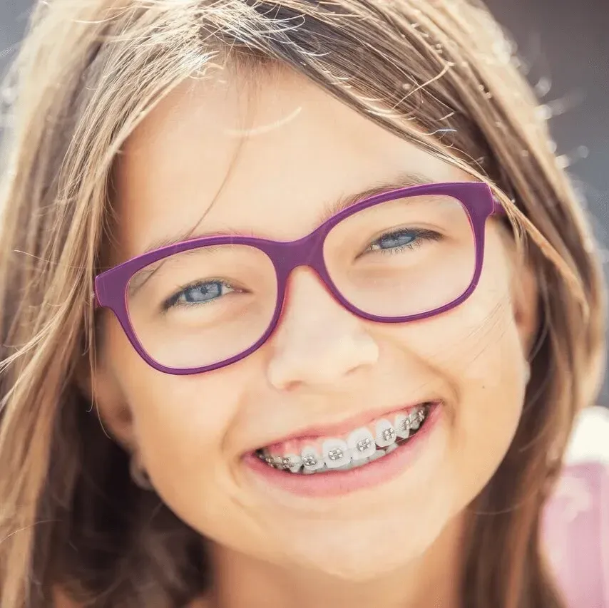 Girl with Glasses and Dental Braces Smiling - Duxton Dental Caring Dentists Christchurch