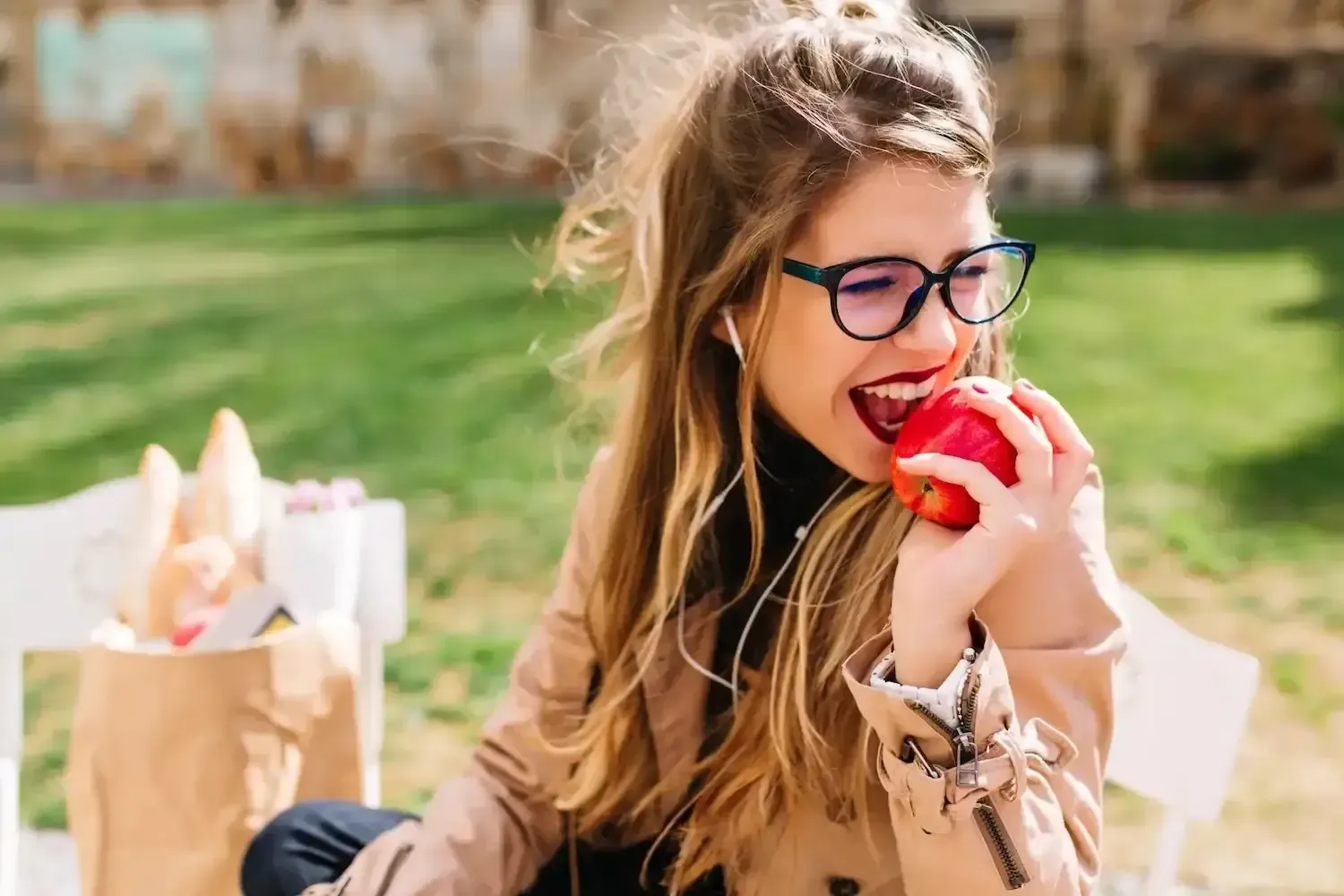 Girl eating an apple with lovely white teeth