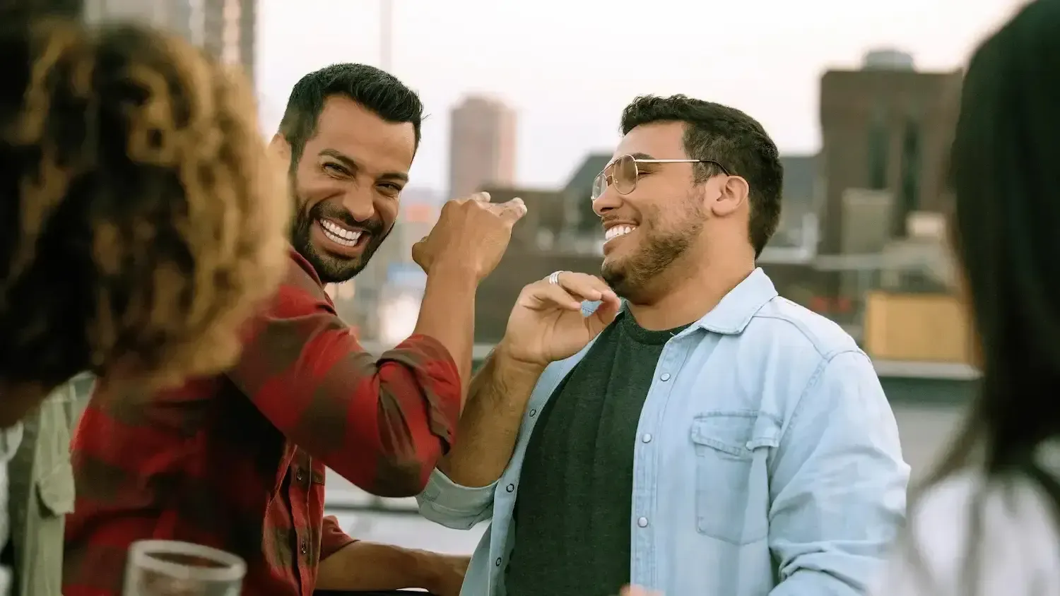 a group of men are having a party on a rooftop .