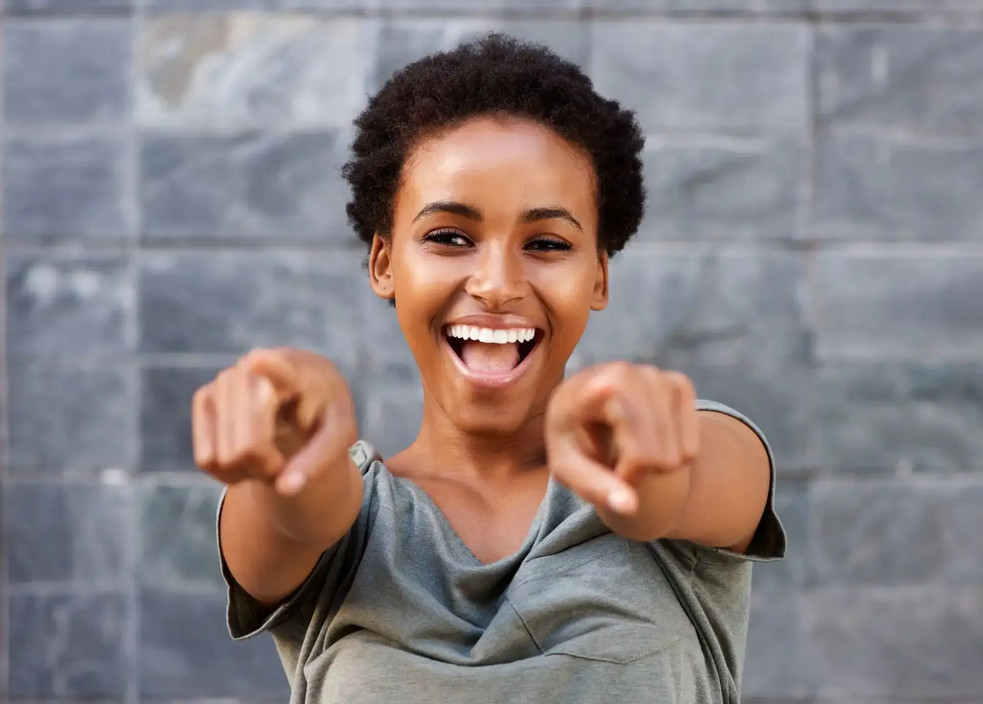 Woman pointing with a nice bright white smile