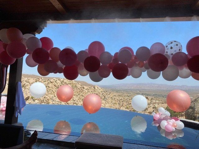Pink & White balloons near pool