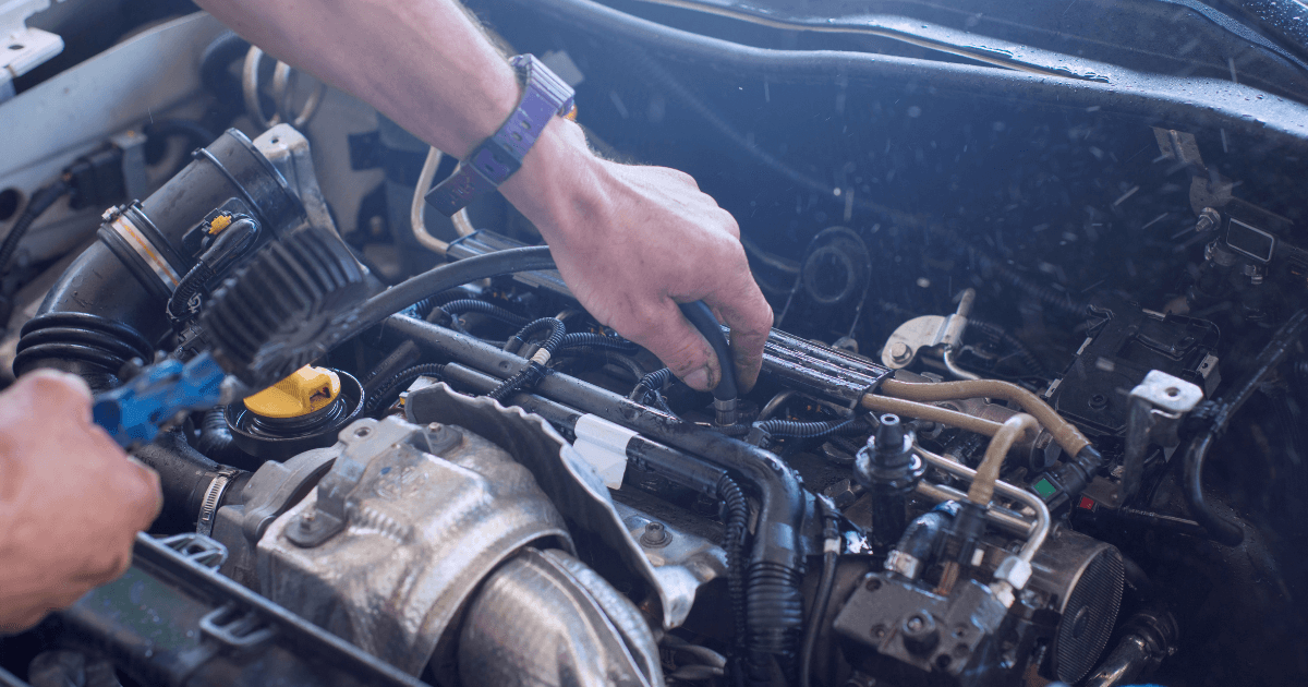 a mechanic under the hood of a car