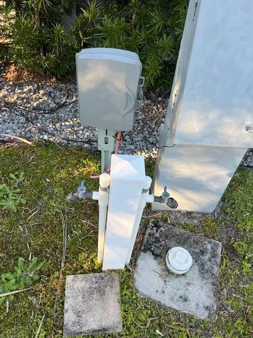Outdoor utility boxes on grass and concrete pads.