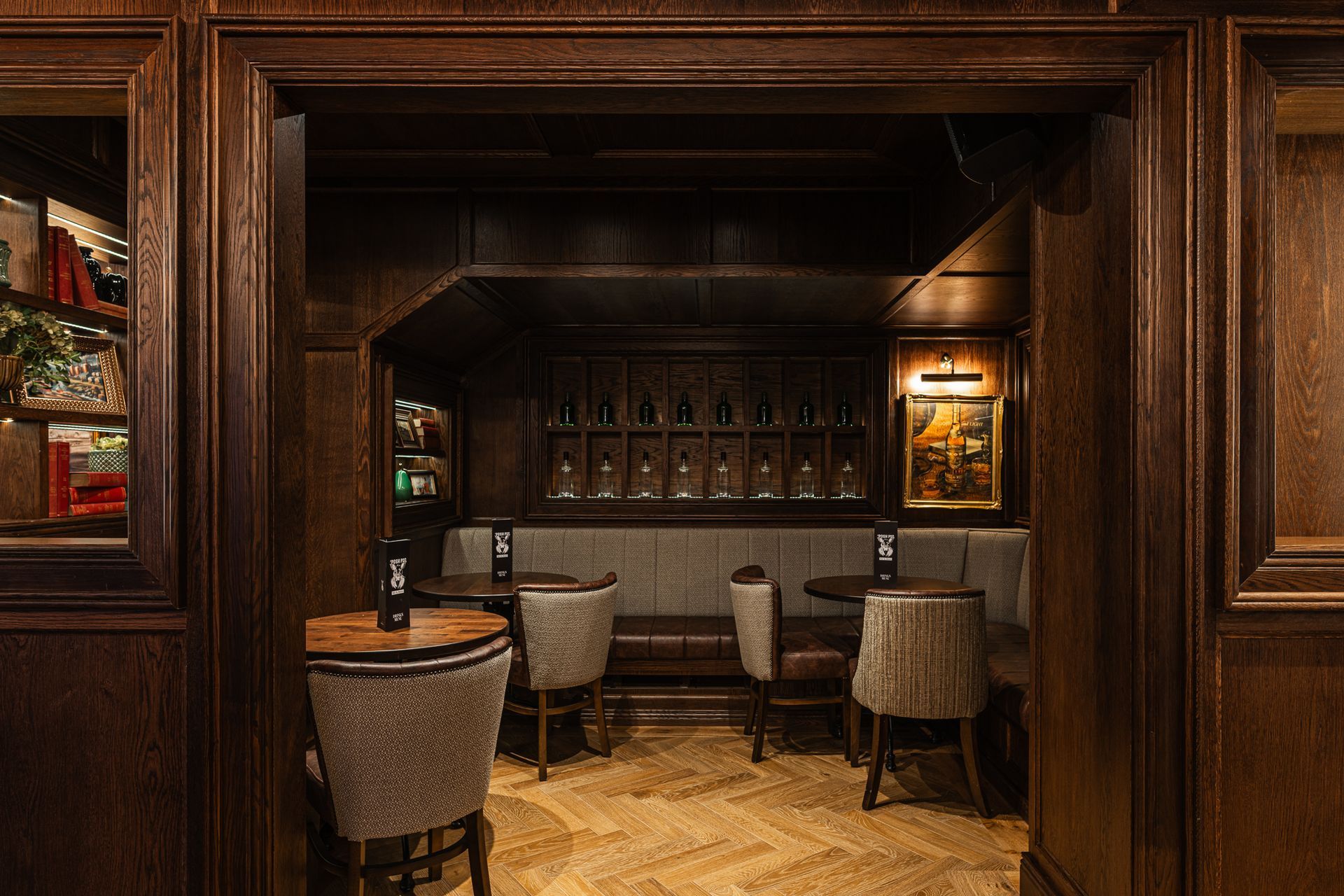 A restaurant with tables and chairs in a dark room.
